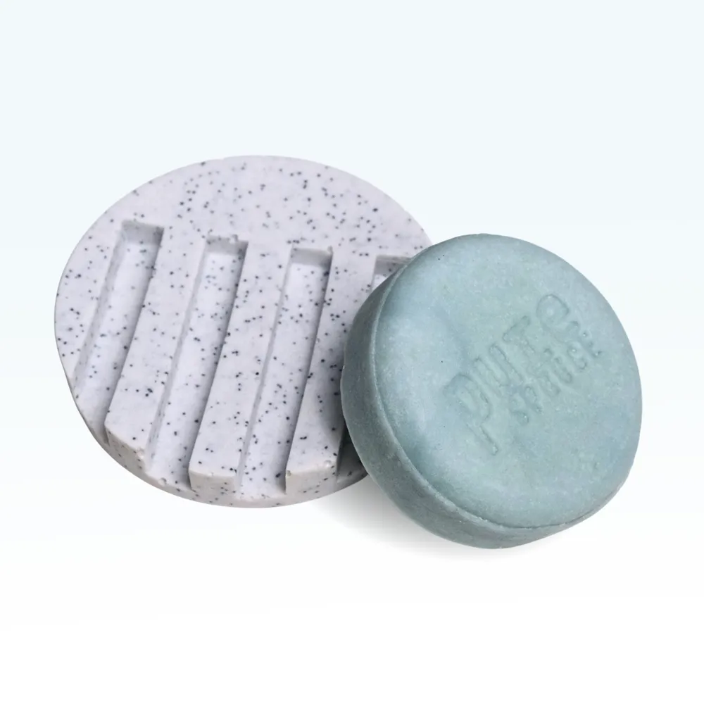 White Circle draining tray Pure Spruce With Clam Sky Shampoo bar beside Quartz texture